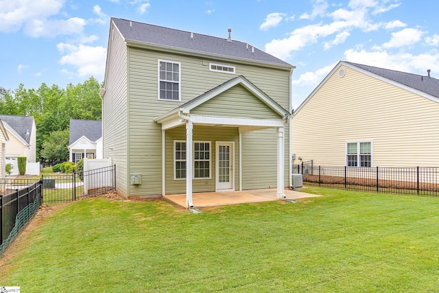 rear view of property with a lawn, a patio, central AC, and a fenced backyard