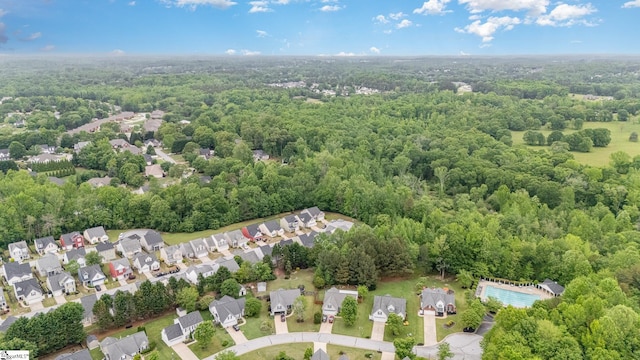 drone / aerial view with a forest view and a residential view