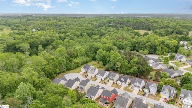 birds eye view of property featuring a view of trees and a residential view