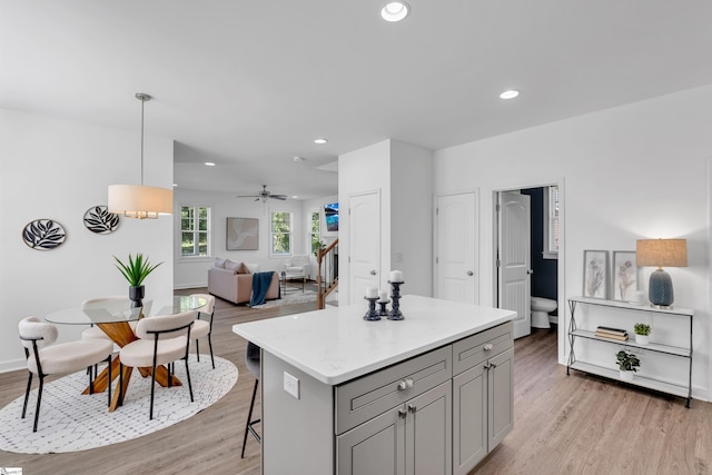 kitchen with open floor plan, gray cabinets, and light wood-style flooring