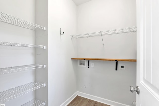 washroom with laundry area, wood finished floors, baseboards, hookup for a washing machine, and electric dryer hookup