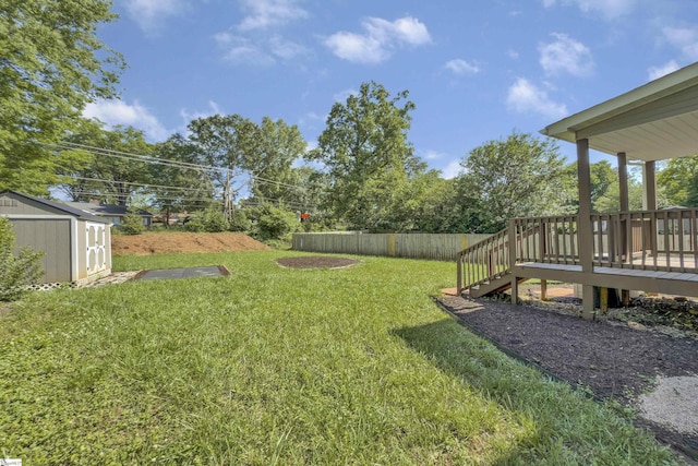 view of yard featuring fence, a deck, a shed, stairway, and an outdoor structure