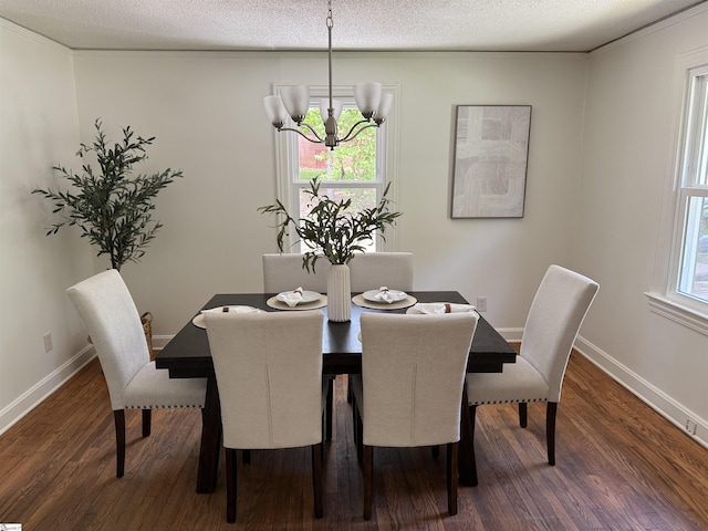 dining area featuring an inviting chandelier, a textured ceiling, dark wood-style flooring, and baseboards