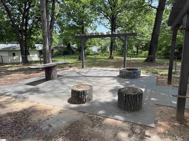 view of patio / terrace featuring fence and a fire pit