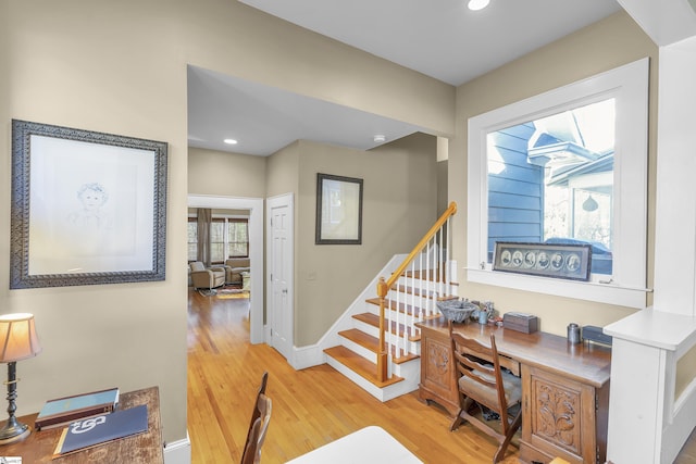 office space featuring recessed lighting, baseboards, and light wood-style flooring