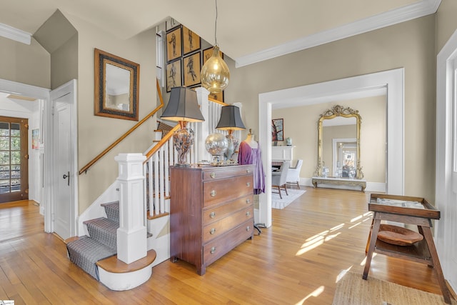 stairway featuring crown molding, baseboards, and wood finished floors