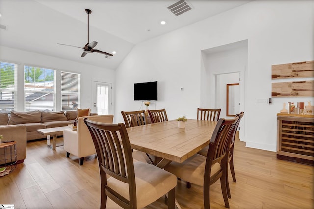 dining space featuring a ceiling fan, visible vents, light wood-type flooring, and wine cooler
