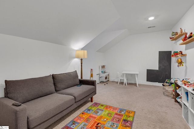 carpeted living room with visible vents and lofted ceiling