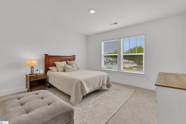 bedroom featuring light colored carpet, baseboards, and visible vents