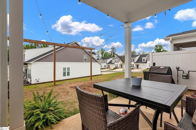 view of patio / terrace featuring grilling area, a residential view, and outdoor dining area