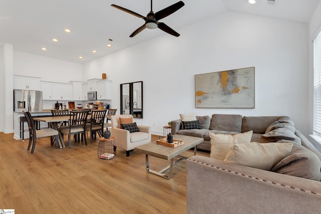 living area featuring recessed lighting, a ceiling fan, light wood-style flooring, and high vaulted ceiling