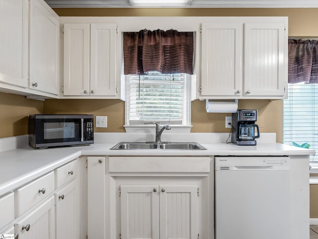 kitchen with white cabinets, white dishwasher, black microwave, and a sink