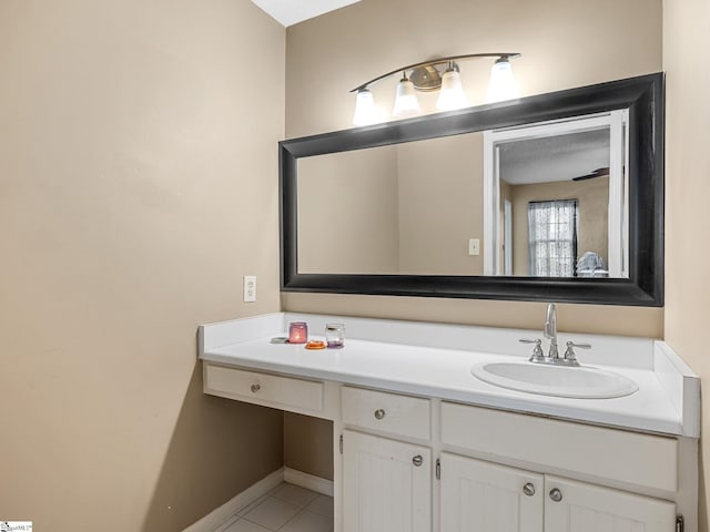 bathroom featuring vanity, baseboards, and tile patterned floors