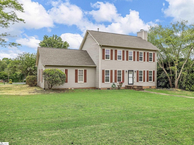 colonial house with a shingled roof, a chimney, and a front lawn