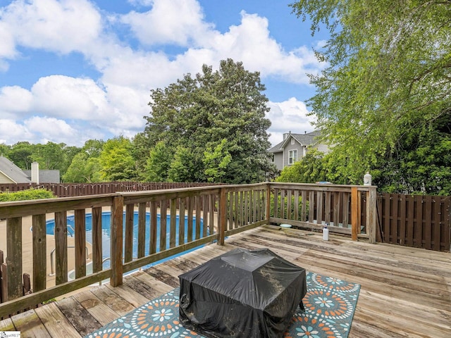 deck featuring an outdoor pool and fence