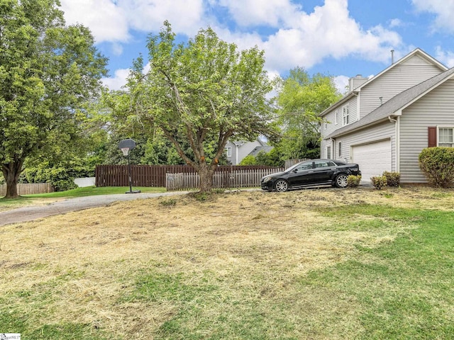 view of yard with a garage and fence