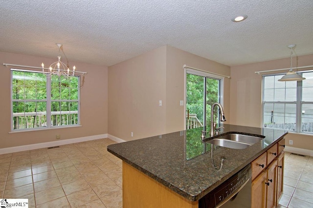 kitchen with a sink, pendant lighting, a textured ceiling, and black dishwasher