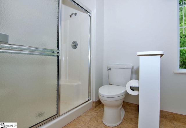full bathroom featuring toilet and a stall shower