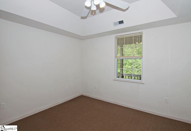 empty room with baseboards, ceiling fan, carpet flooring, and visible vents