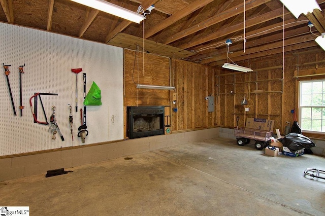 garage featuring a workshop area and a tile fireplace