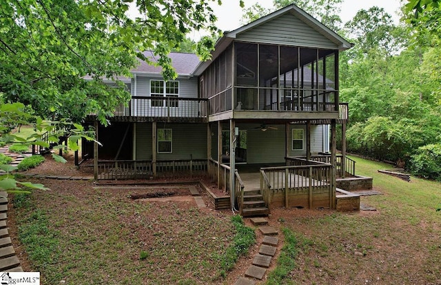 back of house featuring roof with shingles, a ceiling fan, a wooden deck, and a sunroom