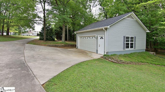garage featuring concrete driveway