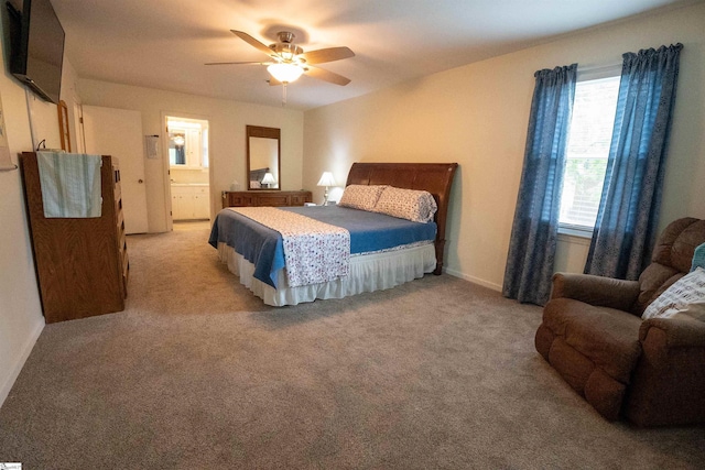 bedroom featuring baseboards, connected bathroom, ceiling fan, and light carpet