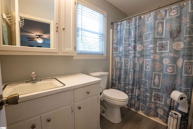 full bathroom with vanity, toilet, a shower with shower curtain, a ceiling fan, and wood finished floors