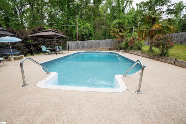 view of pool with a gazebo, a fenced backyard, a fenced in pool, and a patio
