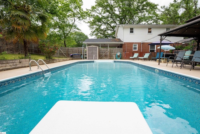 view of swimming pool with a fenced backyard, a fenced in pool, a patio, and a gazebo