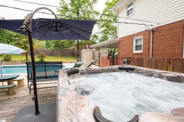 exterior space with a fenced in pool, a fenced backyard, and a hot tub