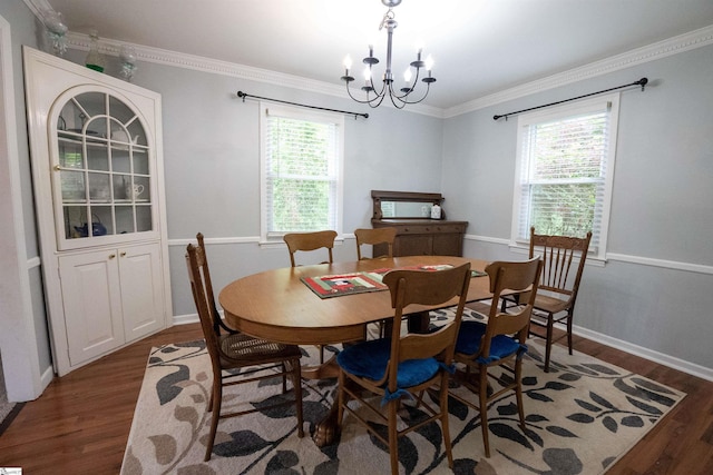 dining area with crown molding, a chandelier, a healthy amount of sunlight, and wood finished floors
