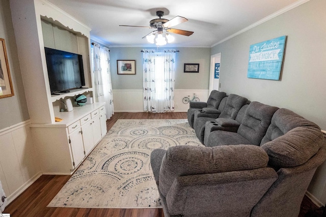 living room featuring wainscoting, ceiling fan, ornamental molding, and wood finished floors