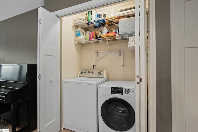washroom featuring separate washer and dryer and laundry area
