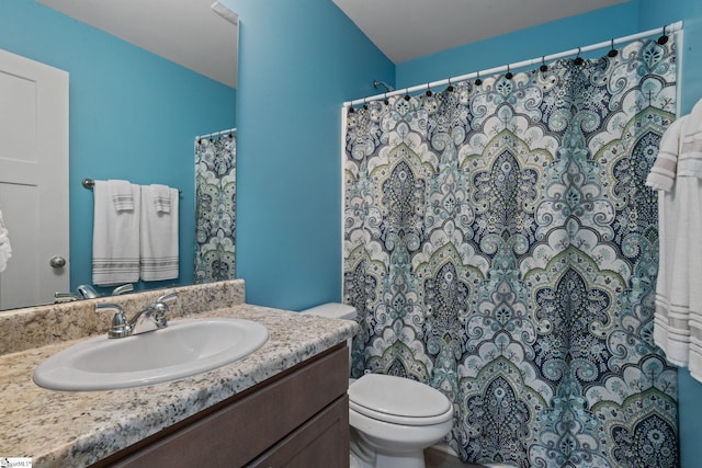 bathroom featuring toilet and vanity