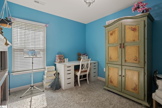 office space featuring visible vents, baseboards, and light carpet