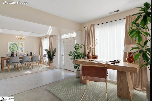 office area with an inviting chandelier and visible vents
