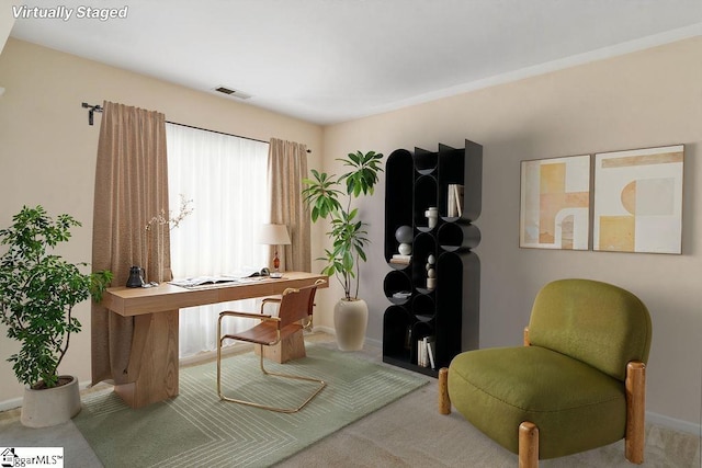 office area with visible vents, baseboards, and carpet floors