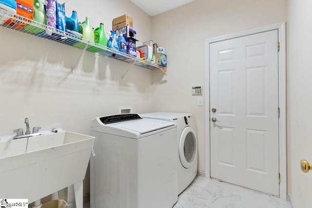 laundry room featuring laundry area, a sink, baseboards, marble finish floor, and separate washer and dryer