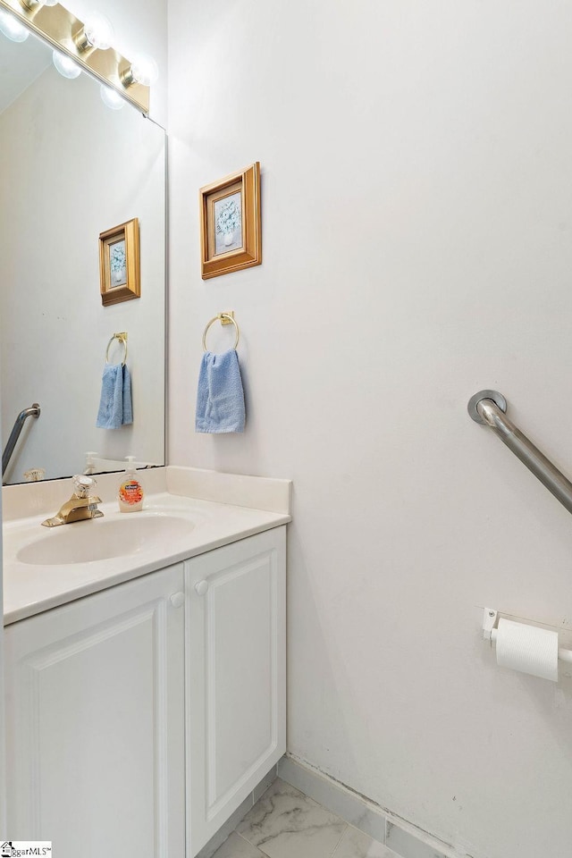 bathroom with marble finish floor and vanity