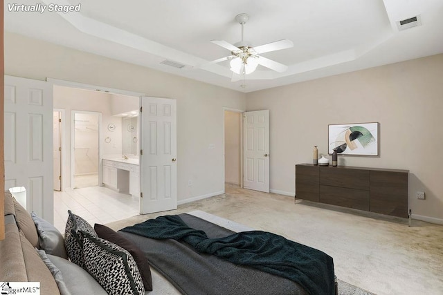 bedroom with baseboards, visible vents, and a raised ceiling