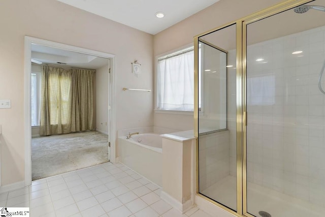 bathroom with tile patterned floors, baseboards, a garden tub, and a stall shower