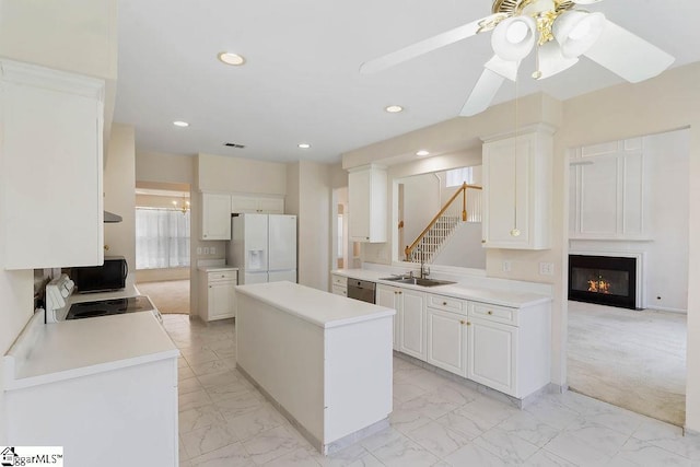 kitchen with ceiling fan, a kitchen island, white appliances, and marble finish floor