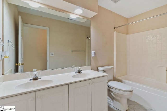 full bath with double vanity, a sink, bathing tub / shower combination, and toilet