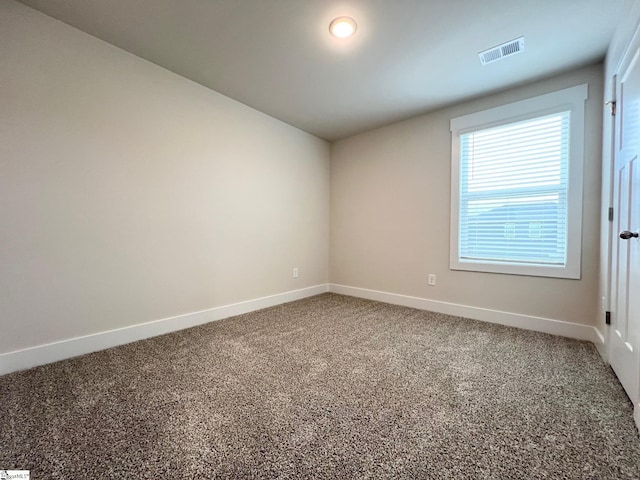 carpeted empty room with baseboards and visible vents