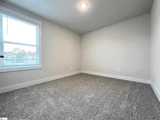 spare room with carpet floors and baseboards