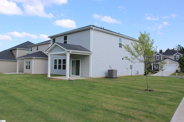 rear view of house with a yard, a patio area, and central air condition unit