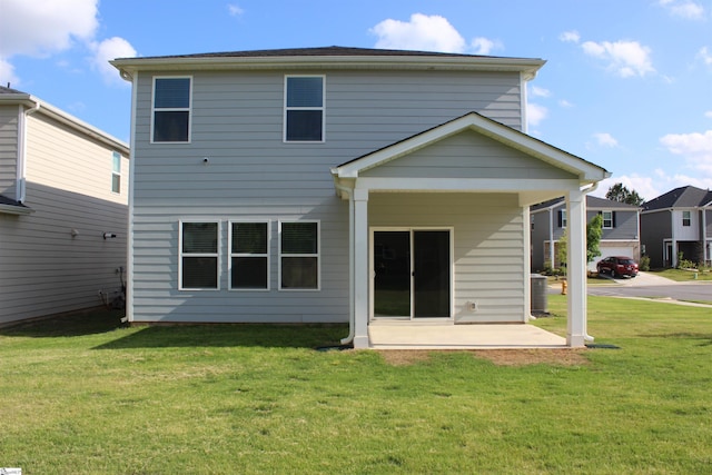 back of property featuring a lawn and a patio area