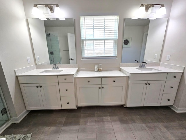 bathroom with a sink, a stall shower, and two vanities