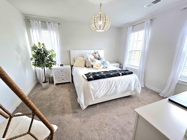 carpeted bedroom with baseboards and visible vents